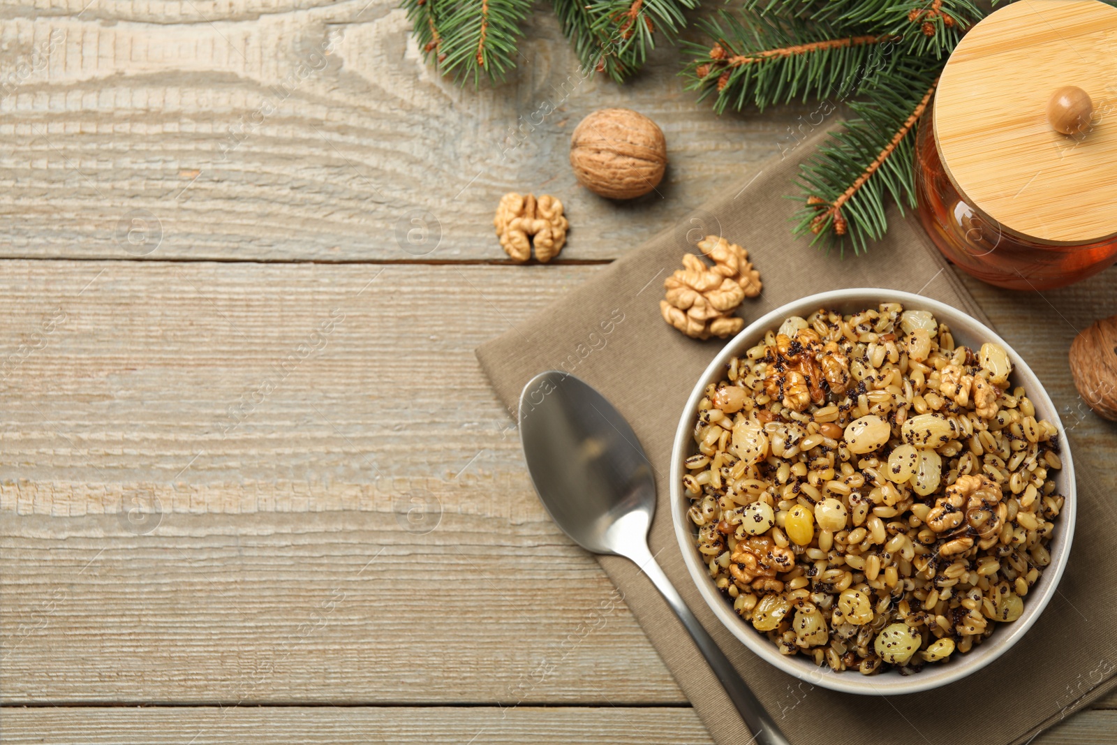 Photo of Traditional Christmas slavic dish kutia served on wooden table, flat lay. Space for text