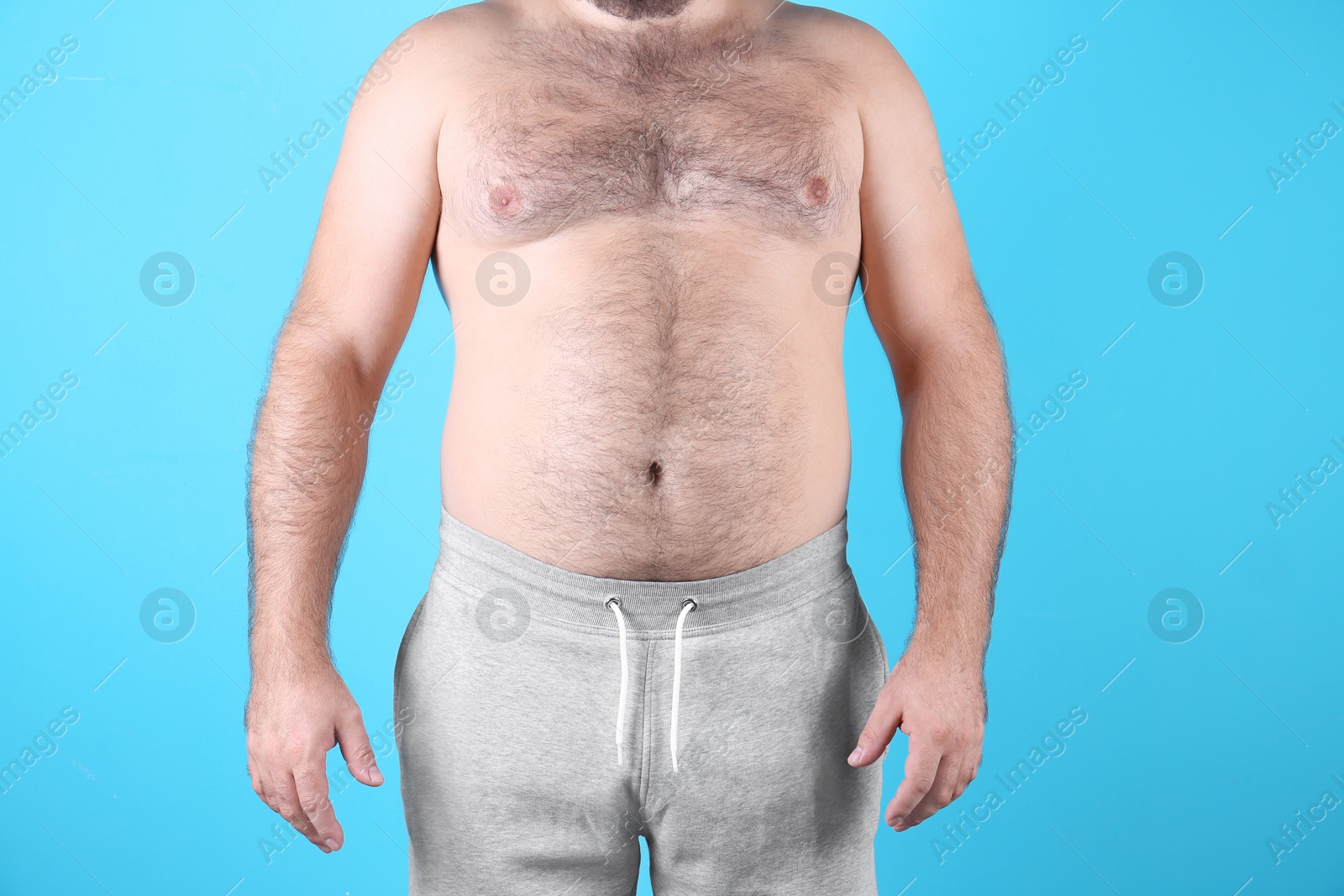 Photo of Fat man on color background, closeup. Weight loss