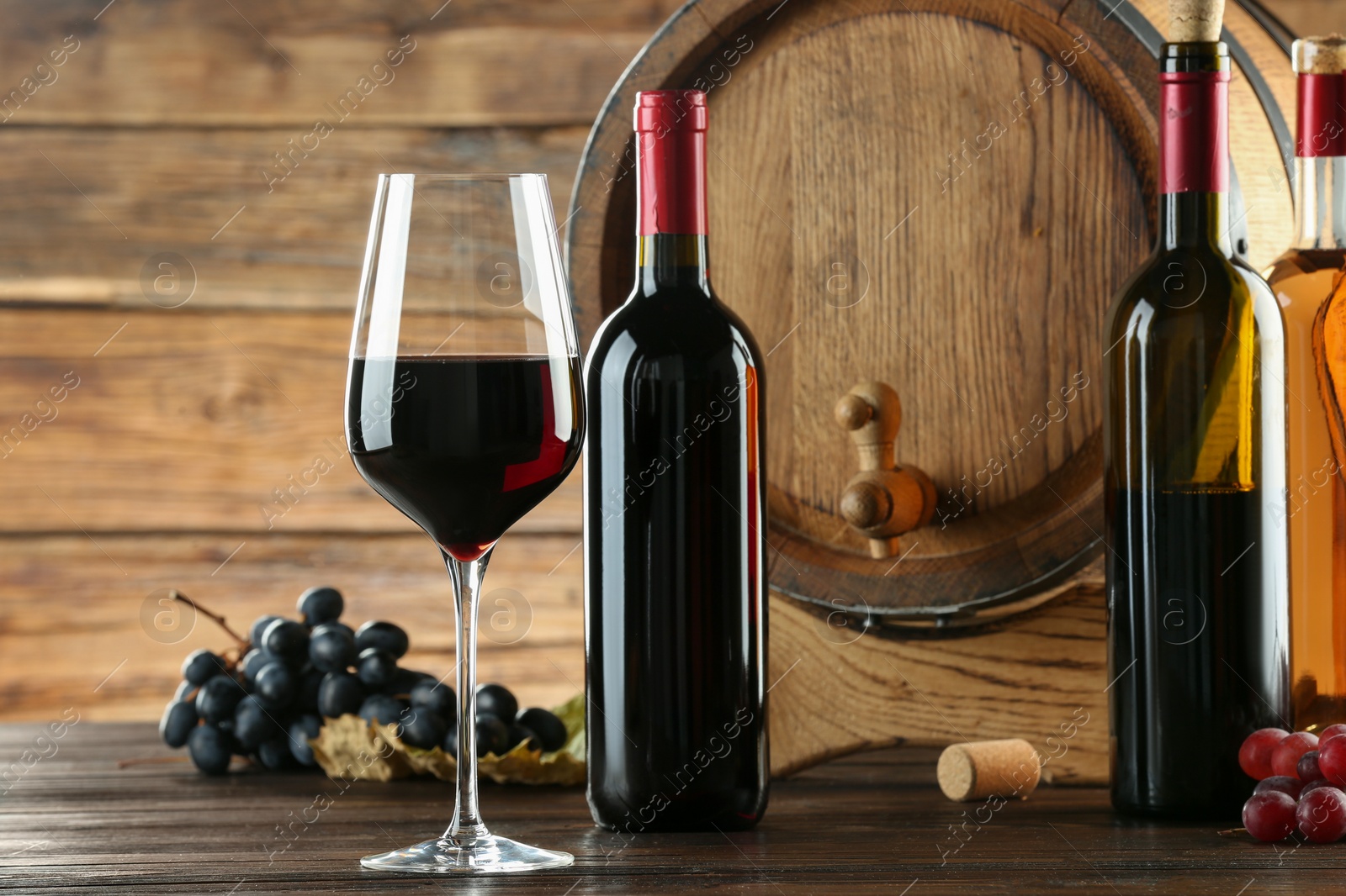 Photo of Winemaking. Composition with tasty wine and barrel on wooden table