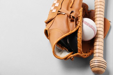 Baseball glove, bat and ball on white background, closeup. Space for text