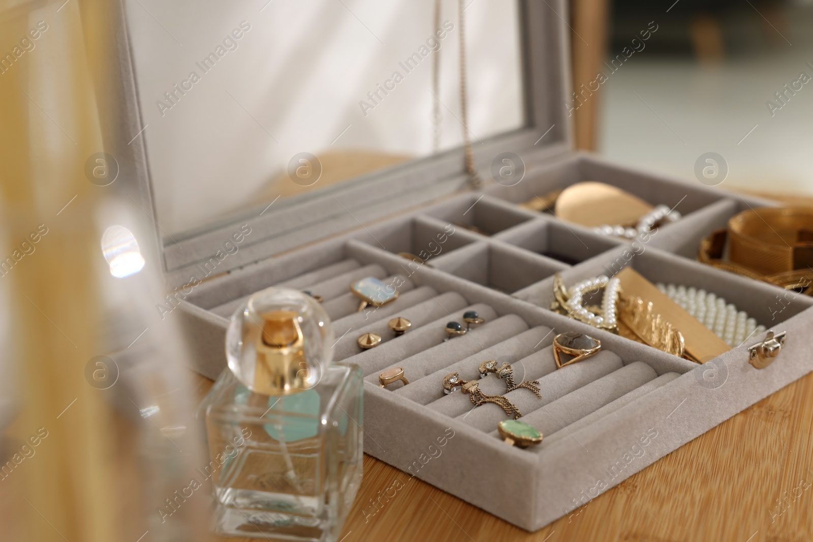 Photo of Elegant jewelry box with beautiful bijouterie on wooden table, closeup