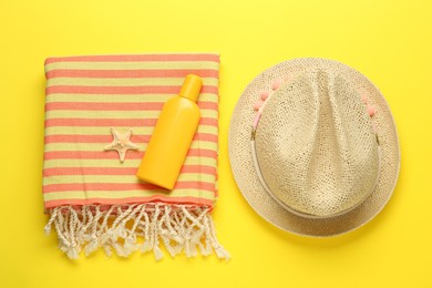 Flat lay composition with different beach objects on yellow background