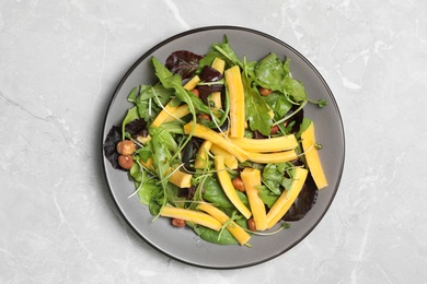 Photo of Delicious fresh carrot salad served on grey marble table, top view