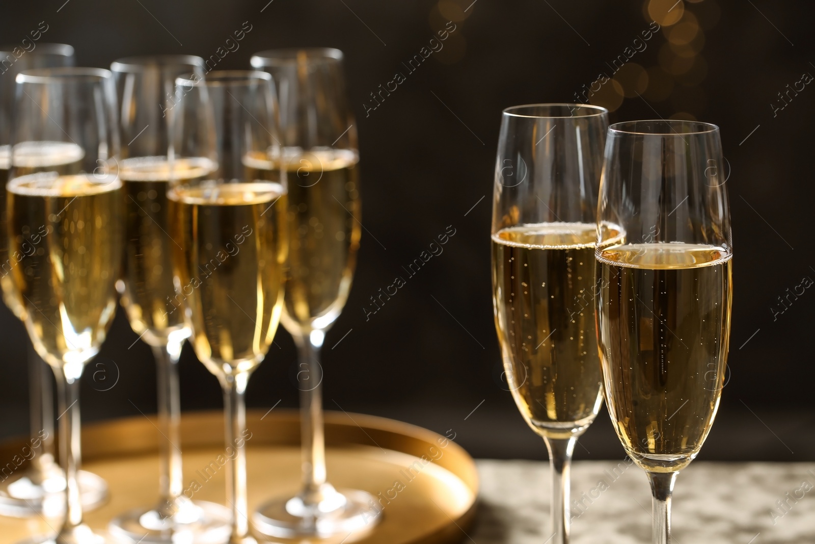 Photo of Glasses of champagne on blurred background, closeup. Space for text