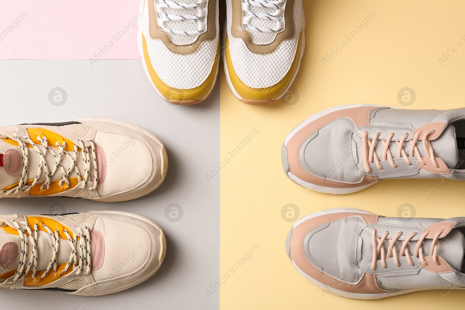 Photo of Different sports shoes on color background, top view