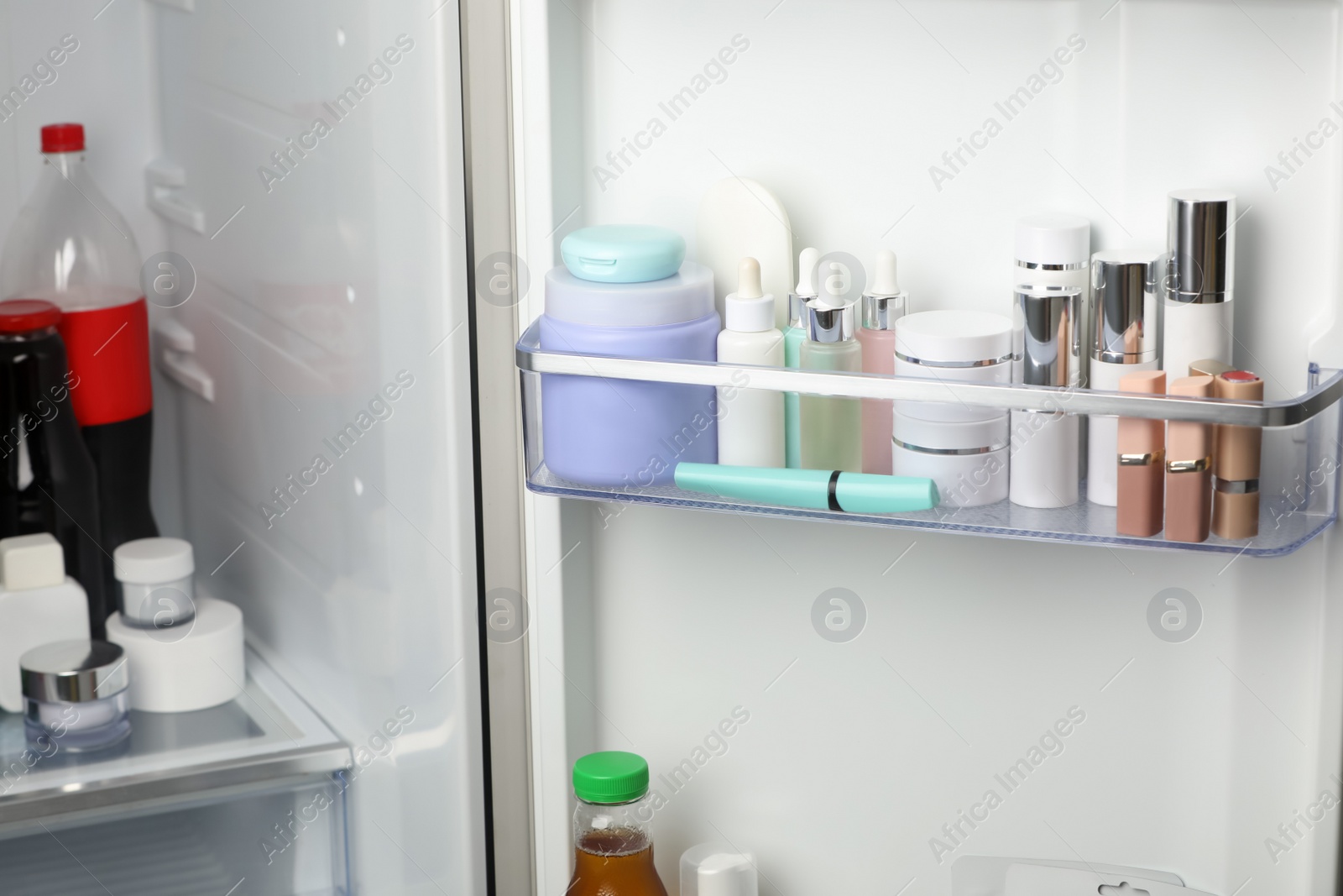 Photo of Different cosmetic products on shelves in refrigerator