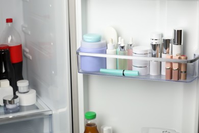 Photo of Different cosmetic products on shelves in refrigerator