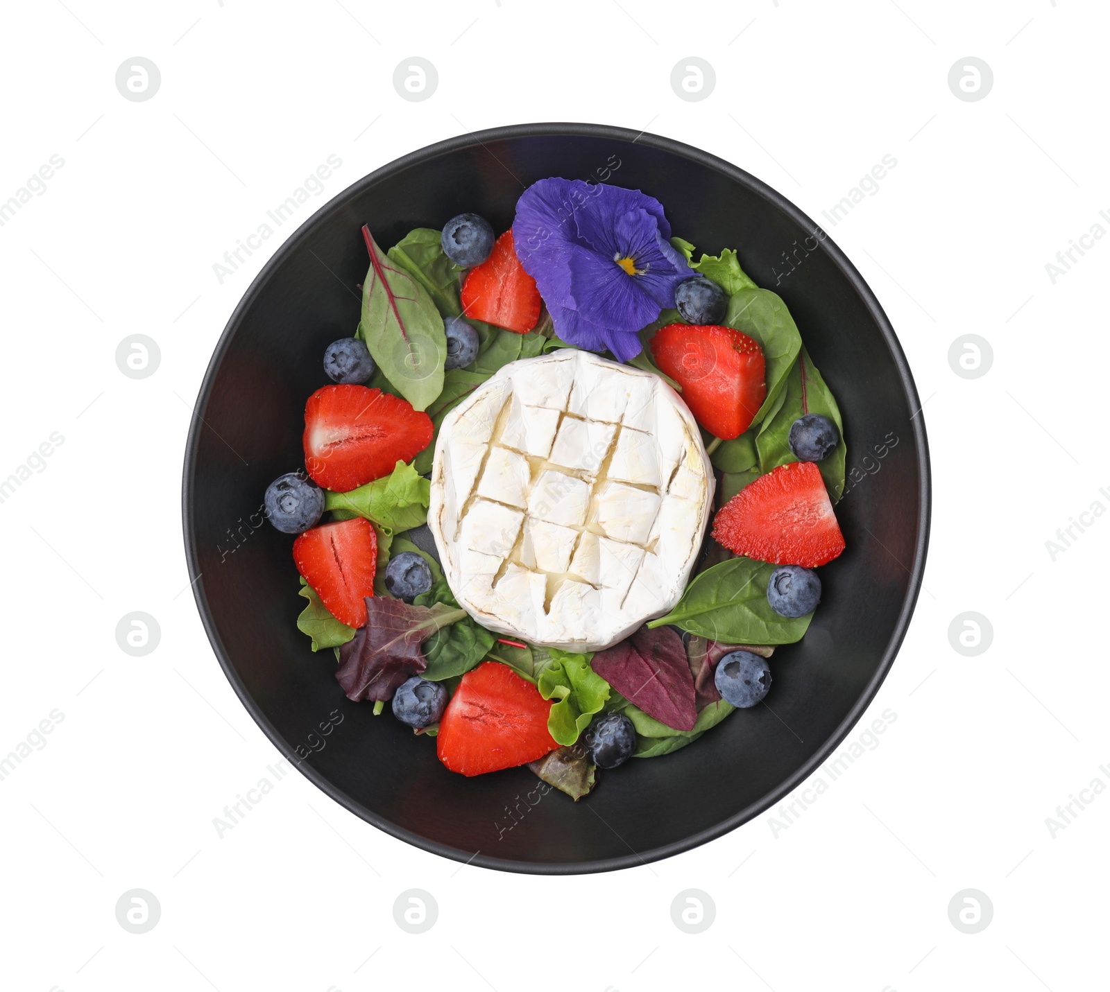 Photo of Bowl of delicious salad with brie cheese, blueberries and strawberries isolated on white, top view