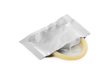 Photo of Torn package with condom isolated on white. Safe sex