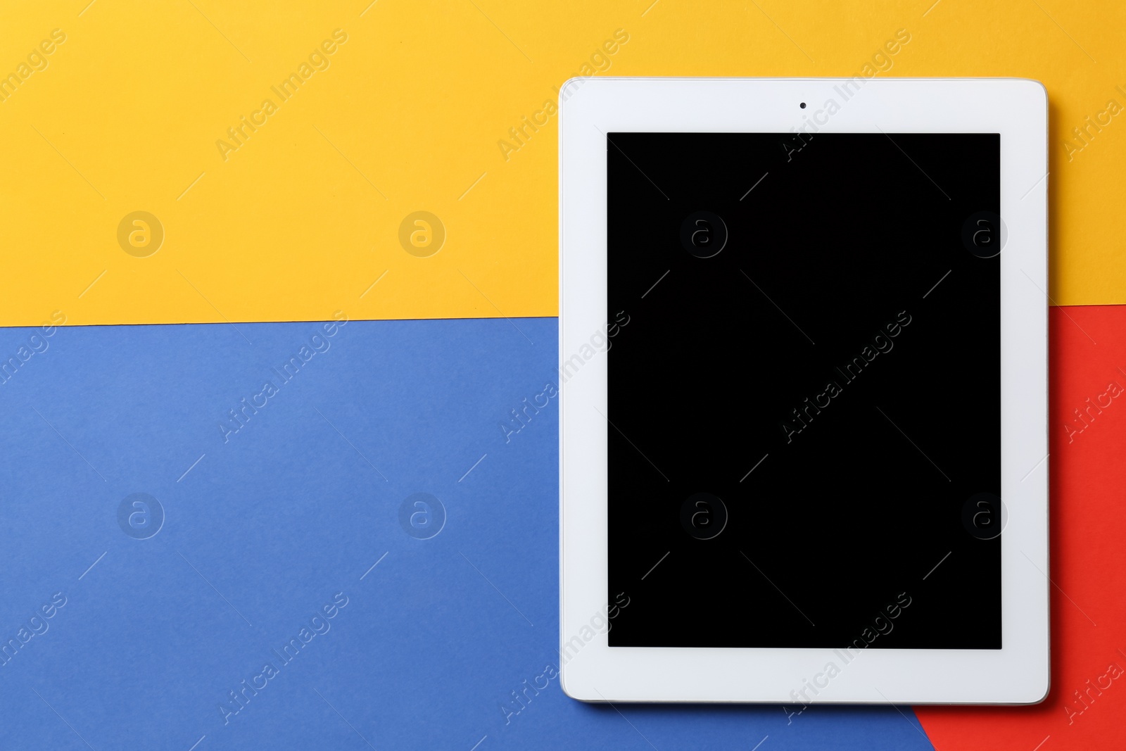 Photo of Modern tablet on color background, top view. Space for text