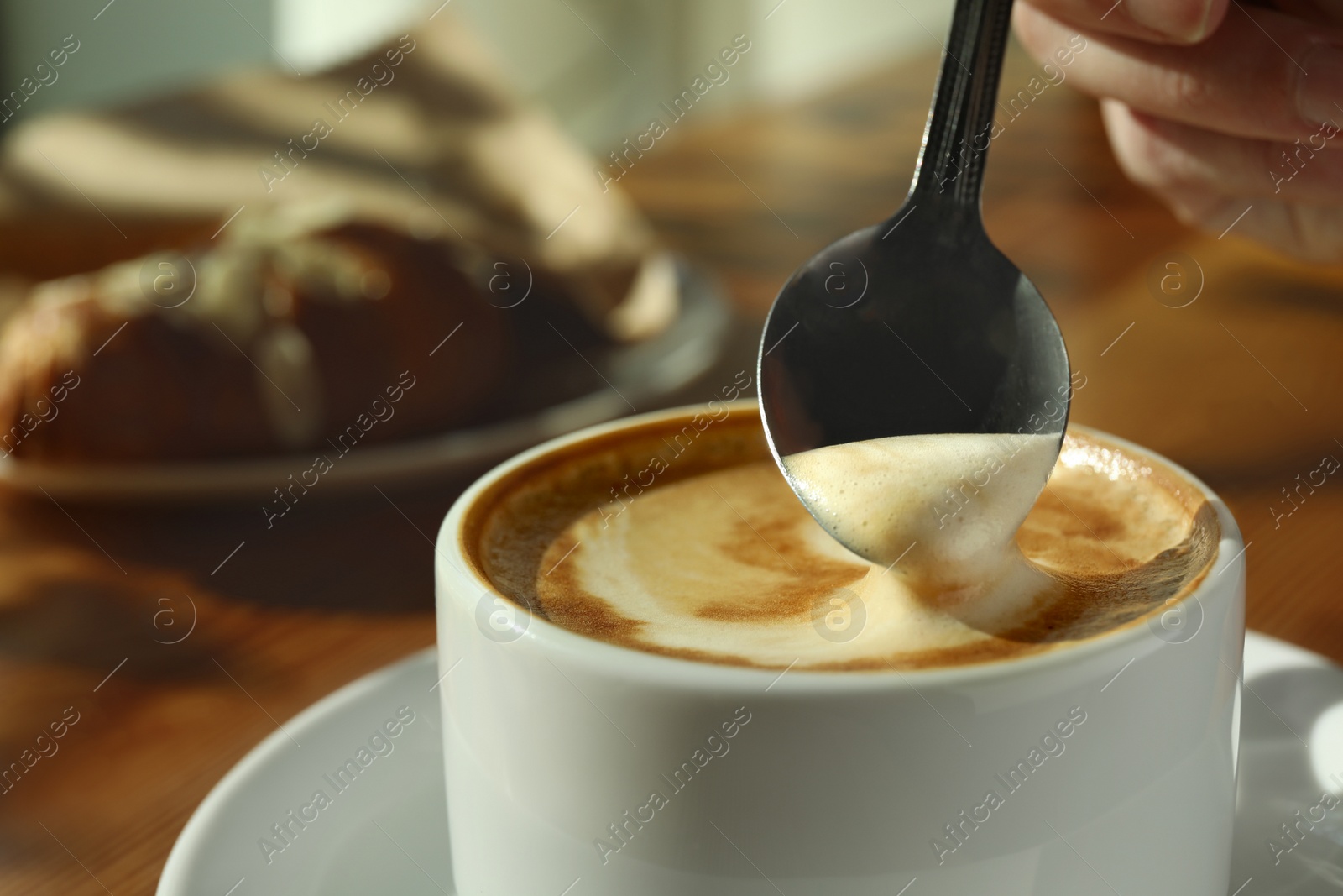 Photo of Cup of fresh aromatic coffee at table in cafe