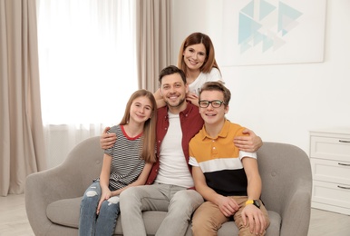 Photo of Happy parents with their teenager children at home