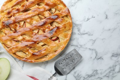 Photo of Fresh traditional apple pie on white marble table, flat lay. Space for text
