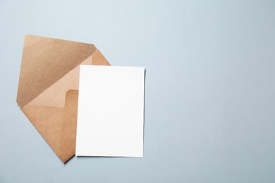 Letter envelope and card on grey background, top view. Space for text