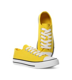 Photo of Pair of yellow classic old school sneakers on white background