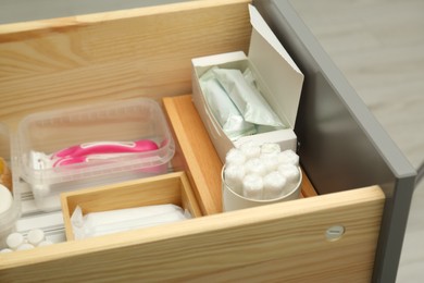 Photo of Storage of different feminine hygiene products in drawer, closeup