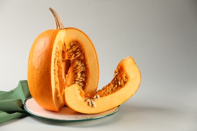 Photo of Cut fresh ripe pumpkin on white background, space for text