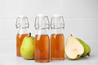 Photo of Tasty kombucha and pears on white table