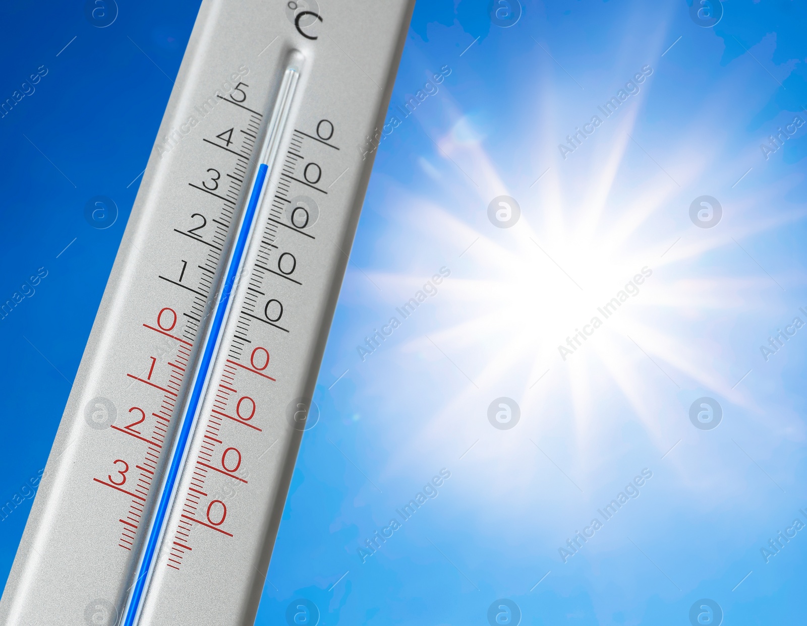 Image of Weather thermometer with high temperature outdoors on hot sunny day. Heat stroke warning