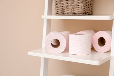 Photo of Toilet paper rolls on shelving unit in bathroom