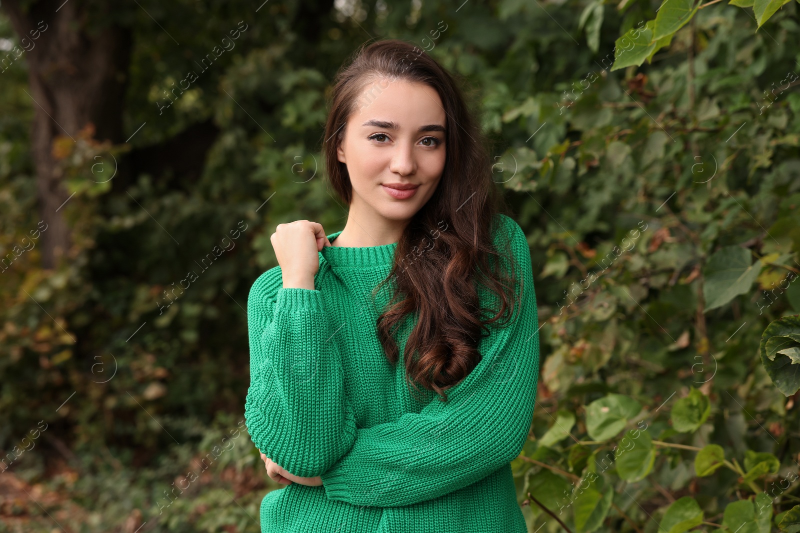 Photo of Beautiful young woman in stylish warm sweater outdoors