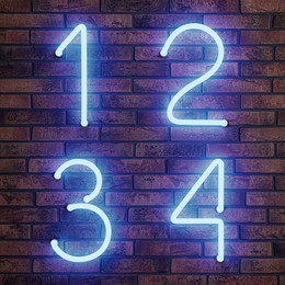 Image of Glowing neon number (1, 2, 3, 4) signs on brick wall