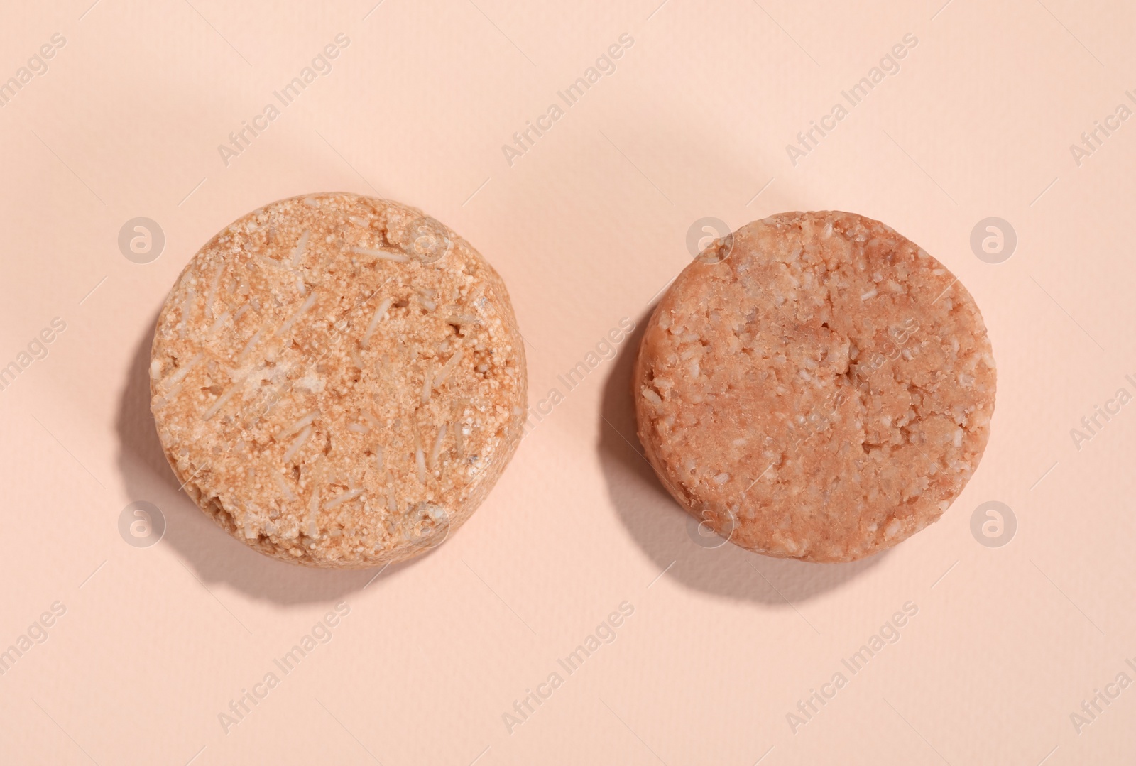 Photo of Solid shampoo bars on pink background, flat lay. Hair care