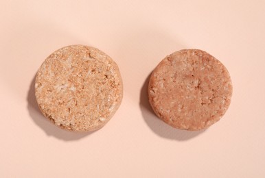 Photo of Solid shampoo bars on pink background, flat lay. Hair care