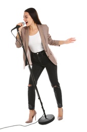 Young stylish woman singing in microphone on white background