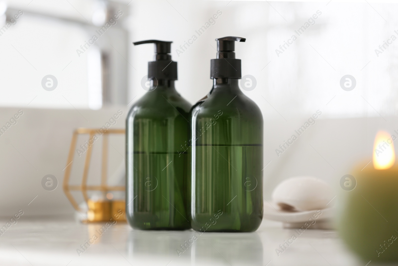 Photo of Green soap dispensers on white countertop in bathroom