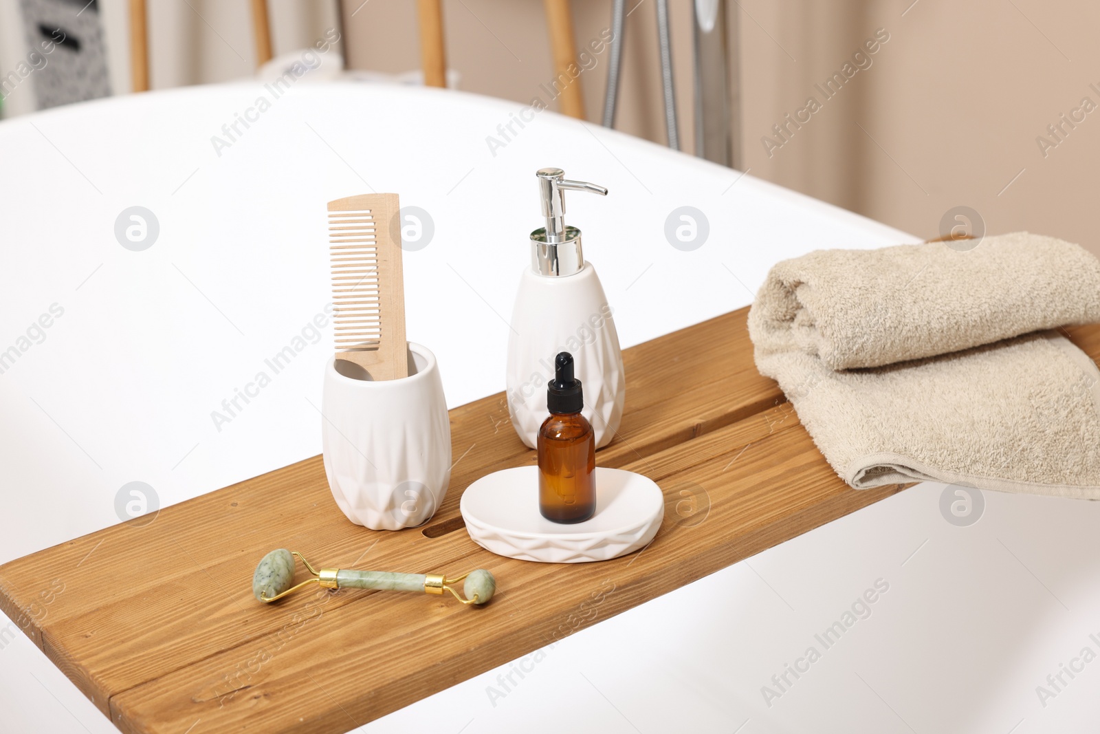 Photo of Different personal care products and accessories on bath tub in bathroom