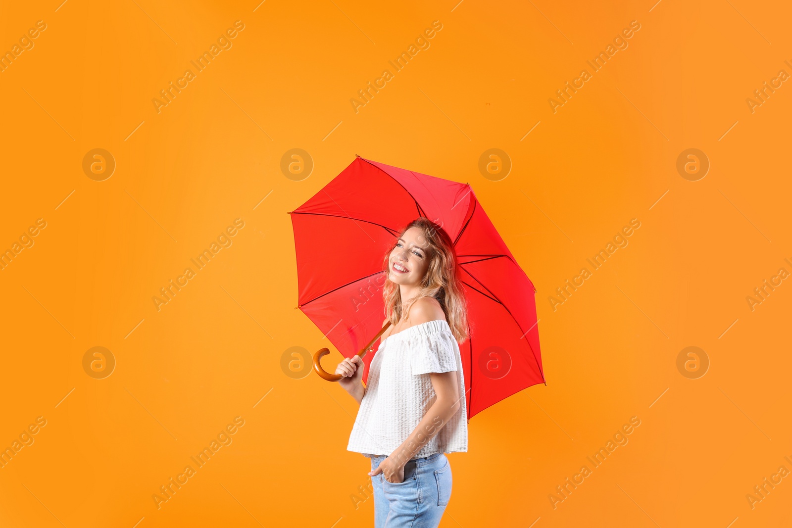 Photo of Woman with red umbrella on color background