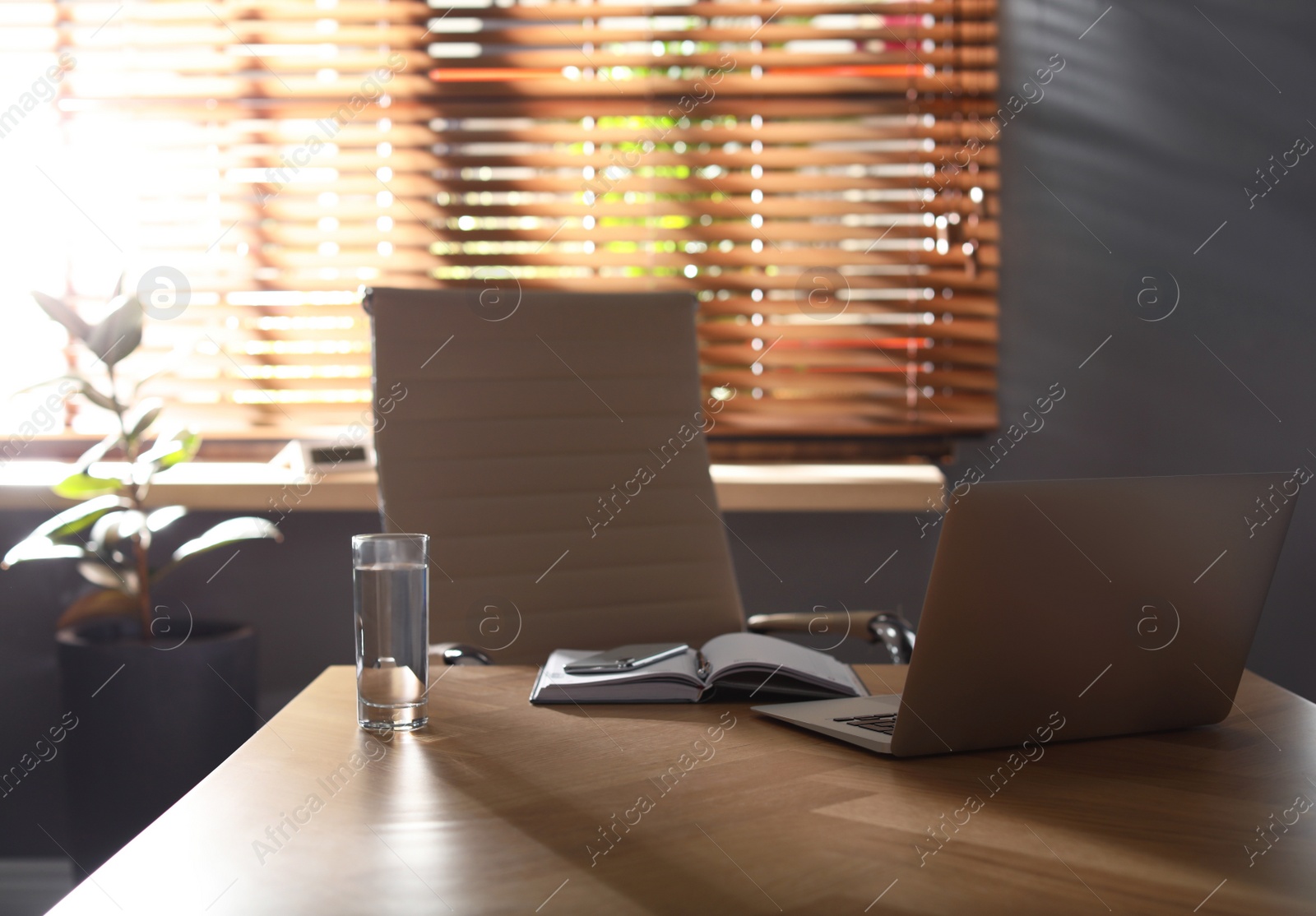 Photo of Laptop on wooden table in modern office