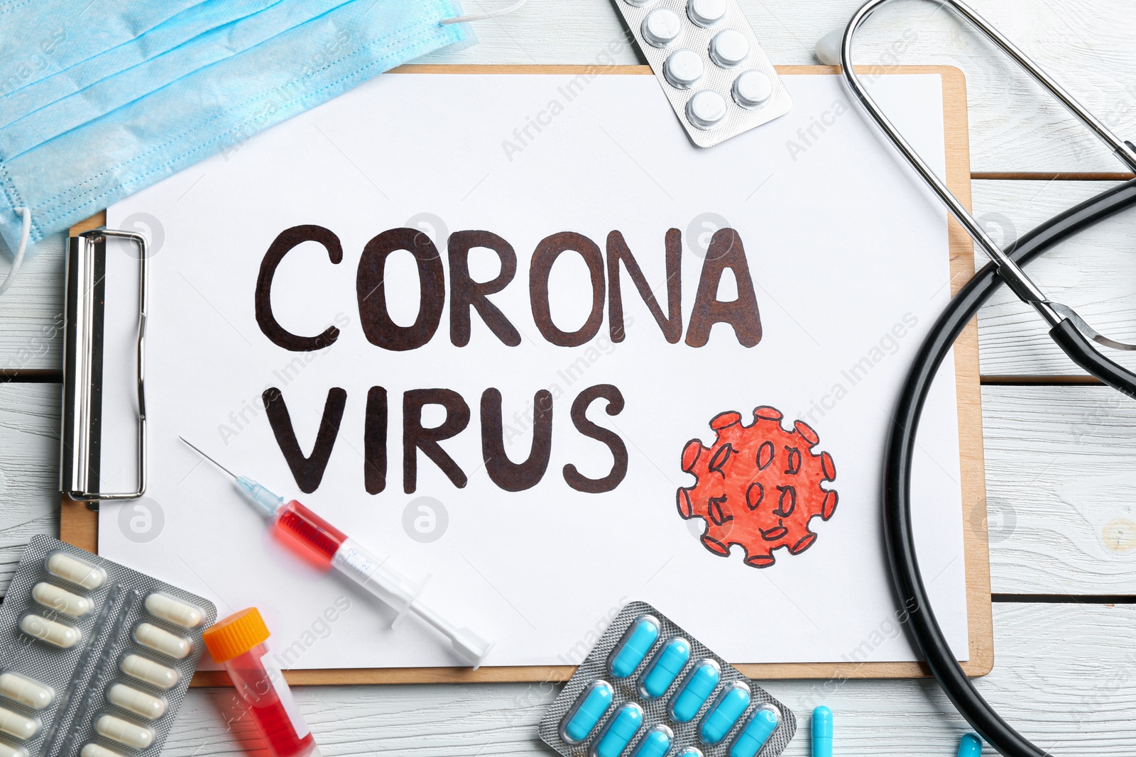 Photo of Flat lay composition of clipboard with words CORONA VIRUS on white wooden background