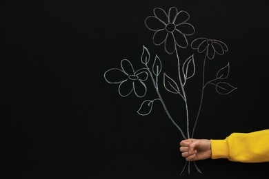 Photo of Woman near black board with chalk drawing of bouquet, closeup. Space for text