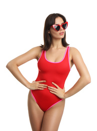 Beautiful young woman wearing swimsuit and sunglasses on white background