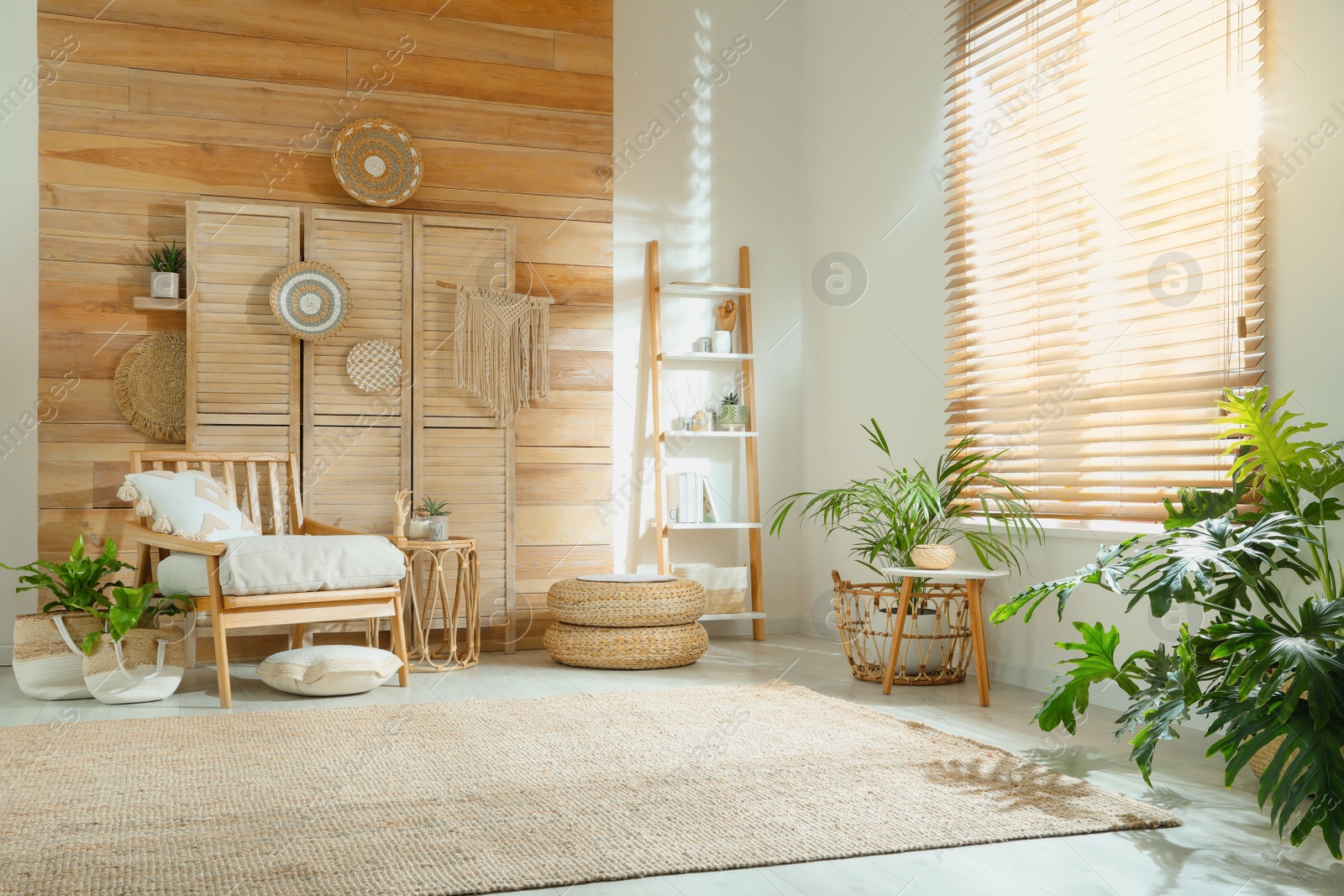 Photo of Stylish living room interior with comfortable wooden armchair and beautiful houseplants