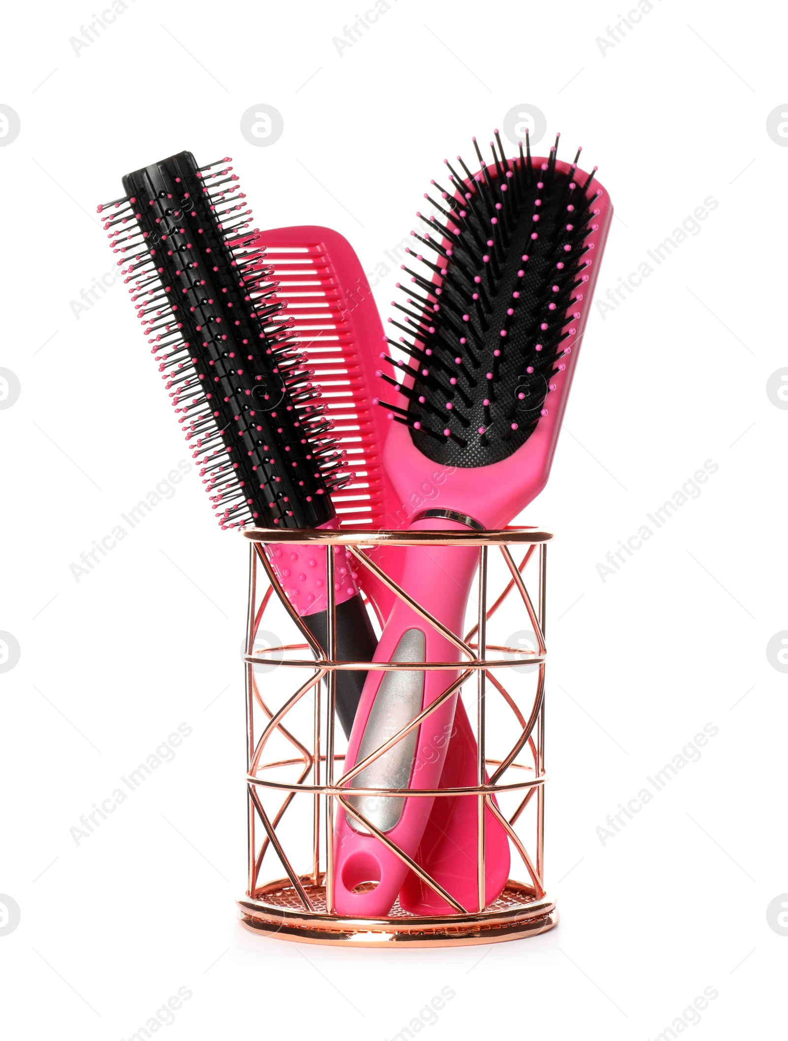 Photo of Hairbrushes and comb in holder on white background