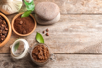 Photo of Composition with handmade natural body scrub and coffee on wooden background