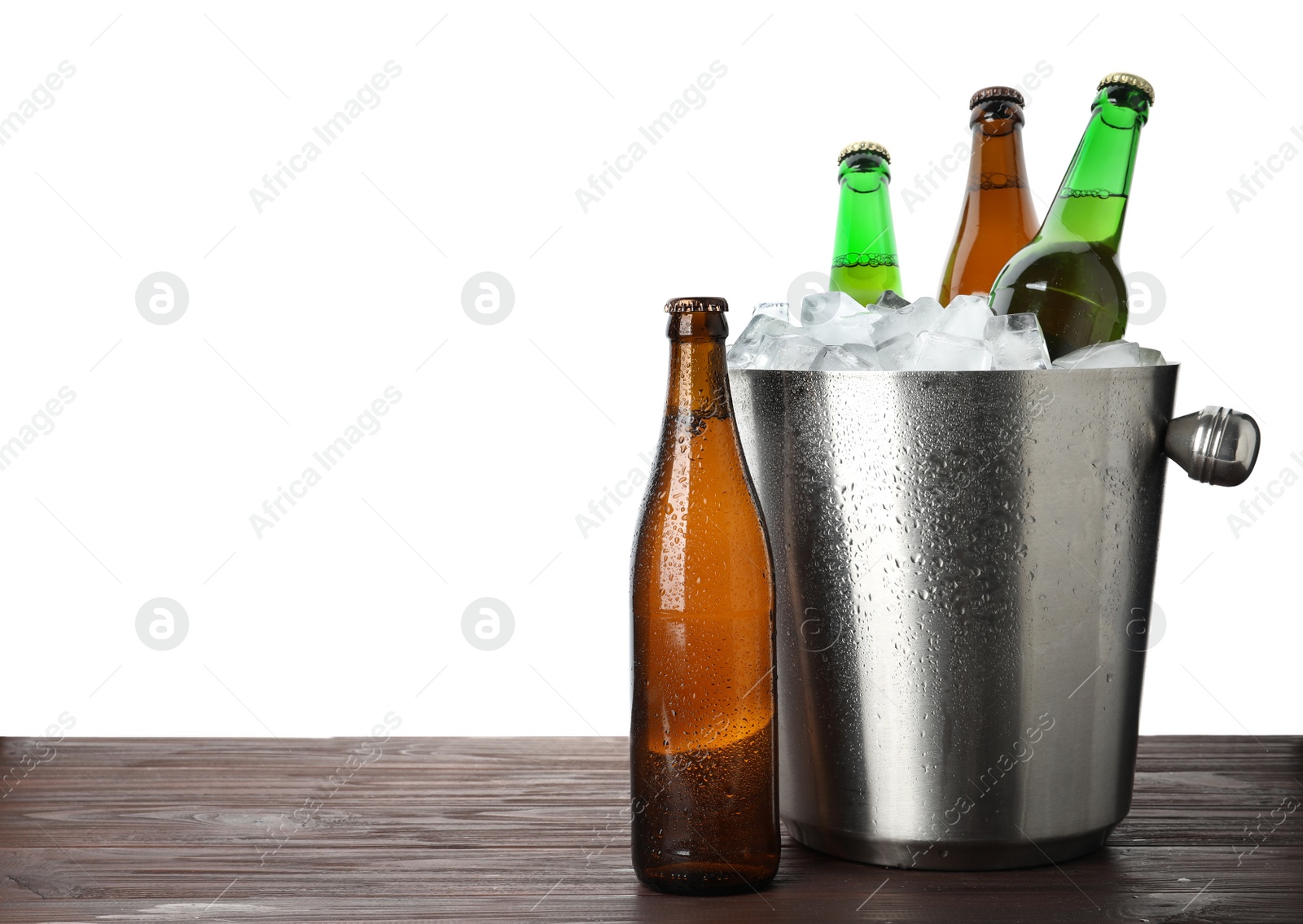 Photo of Metal bucket with bottles of beer and ice cubes on wooden table against white background. Space for text