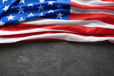 Photo of American flag on grey background, top view with space for text