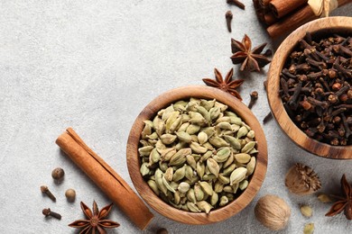 Photo of Different aromatic spices on light textured table, flat lay. Space for text