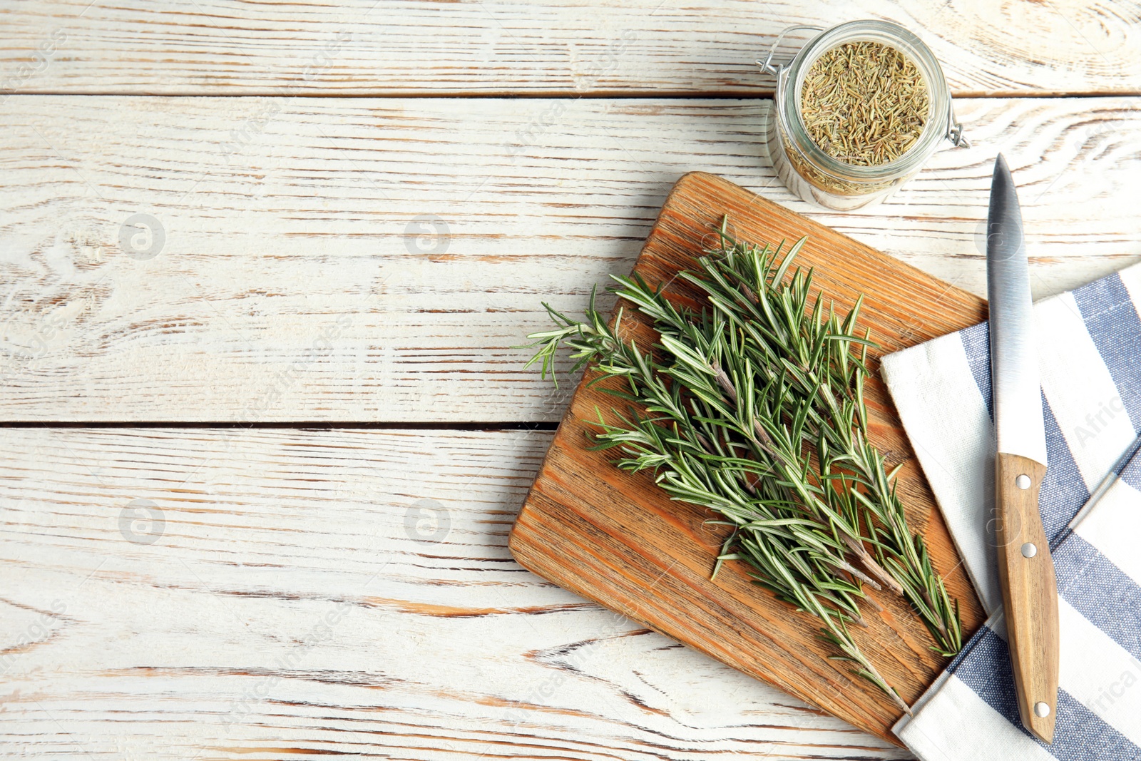 Photo of Flat lay composition with fresh rosemary twigs on wooden table. Space for text