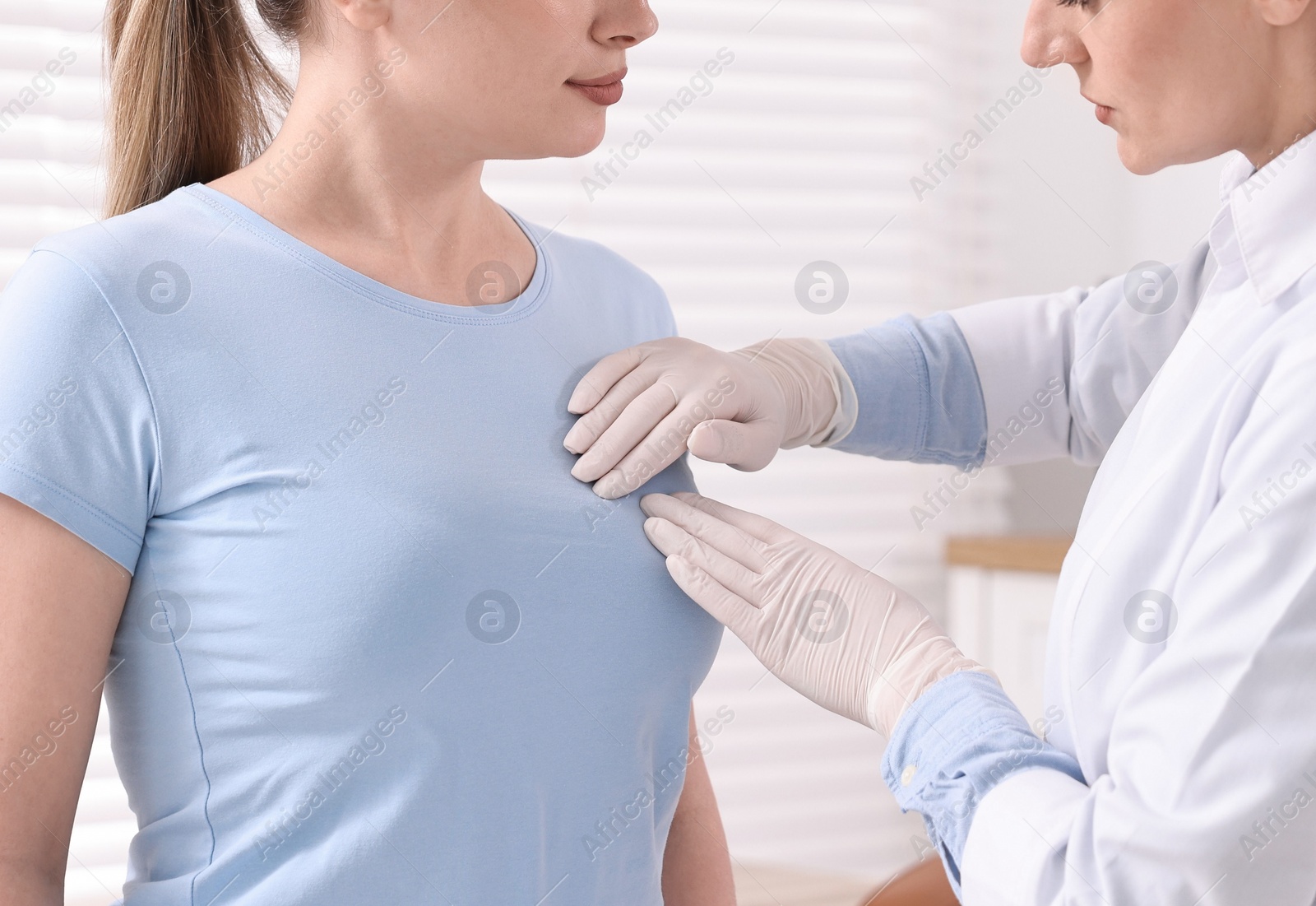 Photo of Mammologist checking young woman's breast in hospital