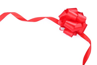 Red satin ribbon with bow on white background, top view