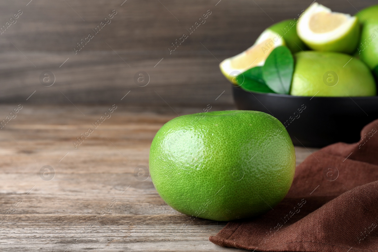 Photo of Fresh ripe sweetie fruit on wooden table, space for text