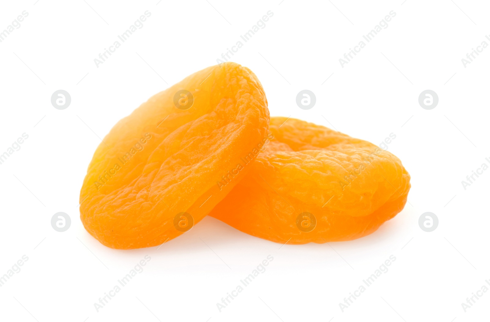 Photo of Two tasty apricots on white background. Dried fruits