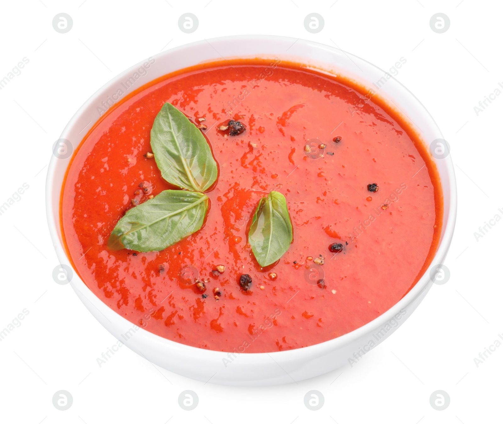 Photo of Delicious tomato cream soup in bowl isolated on white