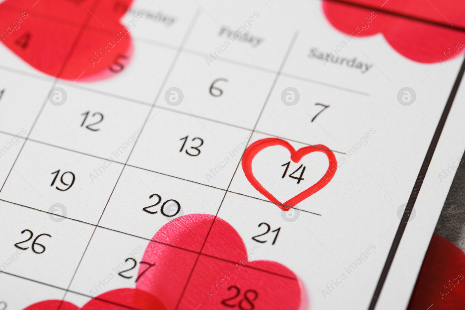 Photo of Calendar with marked Valentine's Day and hearts, closeup