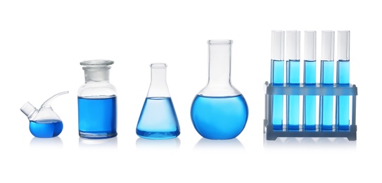 Set of laboratory glassware with blue liquid on white background